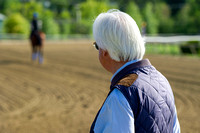 Trainer Bob Baffert watches as American Pharoah heads out for a gallop in preparation for the Preakness Stakes at Pimlico Race Course in Baltimore, Maryland.
