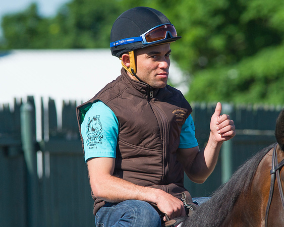 Top rider Joel Rosario gives a thumbs up before heading out on to the track for morning exercises at Belmont Park in Elmont, New York.