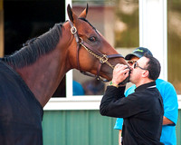 Exercise rider Georgie Alvarez kisses American Pharoah after winning the 147th Belmont Stakes (GI) and becoming the 12th horse to win the Triple Crown.