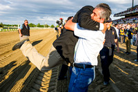 Assistant Trainer Jimmy Barnes gets hugged by groom Eduardo Garcia after American Pharoah wins the 147th Belmont Stakes (GI) and becomes the 12th horse to win the Triple Crown.