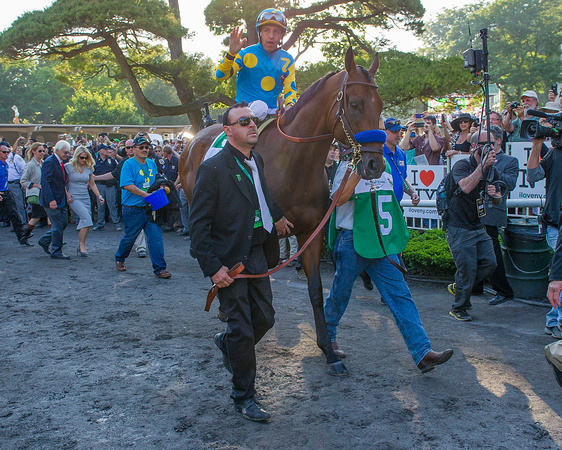 Victor Espinoza waves at fans as American Pharoah walks to the track for the post parade before winning the 147th Belmont Stakes (GI) and becoming the 12th Triple Crown winner at Belmont Park in Elmon