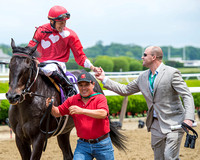 Francisco Torres, aboard Channel Marker, is congratulated by trainer Phillip Bauer after winning the Jaipur Invitational (GIII) at Belmont Park in Elmont, New York.