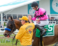 Florent Geroux celebrates with groom Roberto Luna after winning the Latin American Racing Channel Sir Barton Stakes with American Freedom at Pimlico Race Course in Baltimore, Maryland.