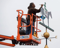Lawrence Jones paints the weather vane on top of the Preakness Cupola in the colors of Big Chief Racing after Exaggerator won the Preakness Stakes at Pimlico Race Course in Baltimore, Maryland.