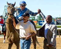 Manuel Franco and trainer Charlton Baker celebrate winning the Grade II True North Stakes with Joking at Belmont Park in Elmont, New York.