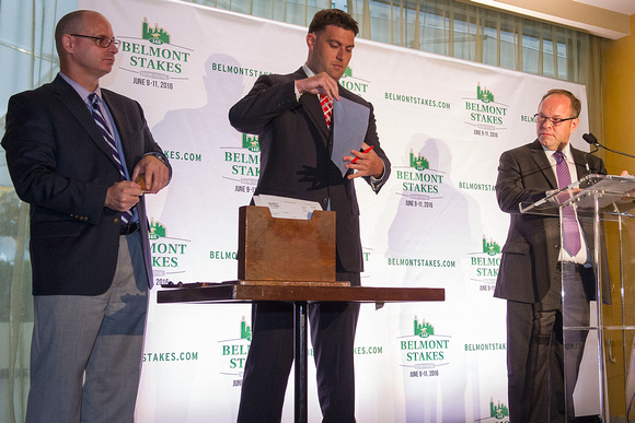 Stakes Coordinator Andrew Byrnes (left), Assistant Racing Secretary Sean Pearl (center), and Track Announcer Larry Collmus (right), draw the Belmont Stakes contender post positions at the Belmont Stak