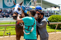 Trevor McCarthy hugs trainer Mario Serey, Jr., after winning the Skipat stakes at Pimlico Race Course in Baltimore, Maryland.