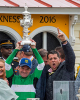 Preakness winning Jockey Kent Desormeaux (left) and co-owner Sol Kumin (right) hoist the trophy at Pimlico Race Course in Baltimore, Maryland.
