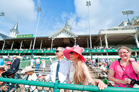 Fans watching a race with the Twin Spires behind them.