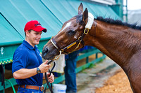 Norman Casse, assistant trainer, smiles at Illinois Derby winner and Preakness Contender Dynamic Impact at Pimlico Race Course in Baltimore, Maryland.
