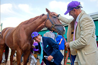 Jockey Victor Espinoza with California Chrome, as exercise rider Willie Delgado looks on, after winning the 139th Preakness Stakes at Pimlico Race Course in Baltimore, Maryland.