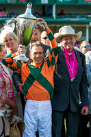 Jockey Kerwin Clark flanked by Trainer Larry Jones, holding the trophy in the winners circle after capturing the Kentucky Oaks (GI) at Churchill Downs in Louisville, Kentucky.