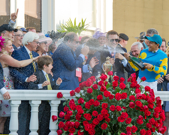 Victor Espinoza celebrates winning the Kentucky Derby (GI) by spraying connections with champagne.