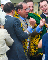 Zayat Stables owner Ahmed Zayat celebrates with some fist pumps while wearing the blanket of Black Eyed Susans after winning the Xpressbet.com Preakness Stakes (GI) with American Pharoah at Pimlico Ra