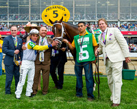 Charles Fipke with rider Joel Rossario and trainer Dallas Stewart pose for a photo with his horse Tale of Verve, who finished second in the Xpressbet.com Preakness Stakes at Pimlico Race Course in Bal