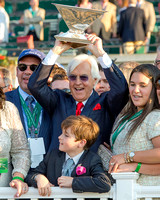 Trainer Bob Baffert raises the Triple Crown trophy in the winner's circle after winning the 147th Belmont Stakes (GI) and the Triple Crown.
