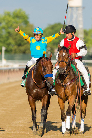 Victor Espinoza celebrates after  American Pharoah won the 147th Belmont Stakes (GI) and became the 12th thoroughbred race horse to win the Triple Crown.
