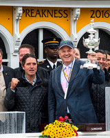 Matt Bryan, owner of Preakness Stakes winner Exaggerator, holds up the trophy at Pimlico Race Course in Baltimore, Maryland.