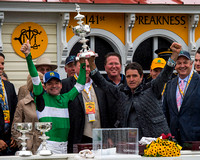 Preakness winning Jockey Kent Desormeaux (left)  and trainer Keith Desormeaux (right) hoist the trophy at Pimlico Race Course in Baltimore, Maryland.