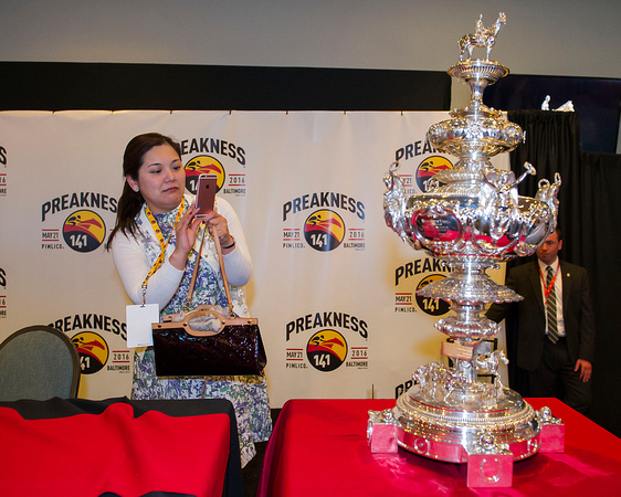 Connections of Preakness contender Lani, takes a picture of the Woodlawn Vase trophy at the Preakness Post Position draw at Pimlico Race Course in Baltimore, Maryland.