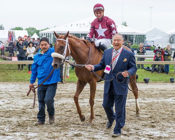 Owner Randy Lowe (right) leads Lady Shipman into the winners circle after the The Very One Stakes at Pimlico Race Course in Baltimore, Maryland.