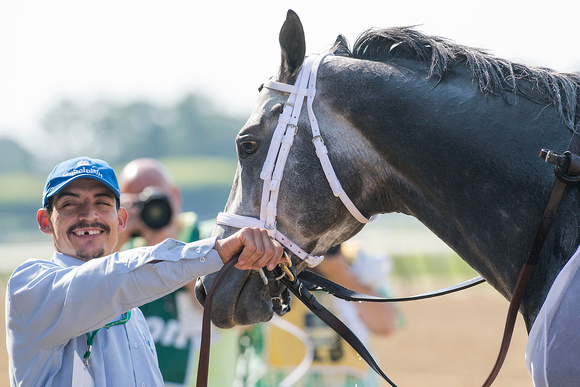 Groom of Frosted is all smiles after winning the Grade I Metropolitan Mile Stakes at Belmont Park in Elmont, New York.