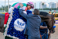Assistant trainer Jimmy Barnes hugs rider Mike Smith after winning the 2017 Pegasus World Cup Invitational at Gulfstream Park.