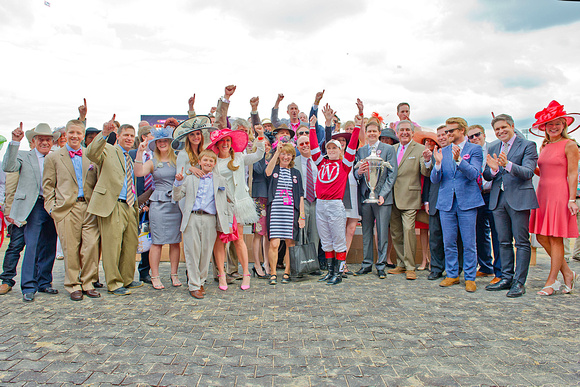 Connections of Kentucky Oaks 140 winner Untapable celebrate in the winner's circle at Churchill Downs.