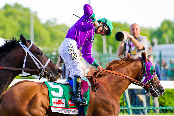 Victor Espinoza fist pumps after winning the 140th Kentucky Derby aboard California Chrome.