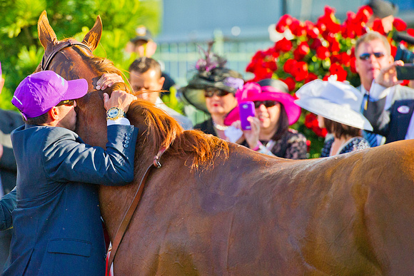 California Chrome gets a hug and kiss from his exercise rider Willy Delgado after winning the 140th Kentucky Derby.