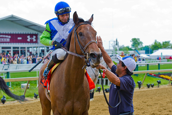 Luis Garcia celebrates after winning the Very One Stakes with Ageless at Pimlico Race Course in Baltimore, Maryland.