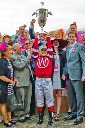 Rosie Napravnik hoists the Kentucky Oaks trophy after winning the 140th Kentucky Oaks aboard Untapable.