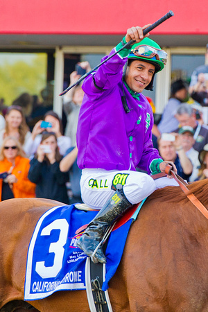 Jockey Victor Espinoza celebrates after winning the 139th Preakness Stakes at Pimlico Race Course in Baltimore, Maryland.
