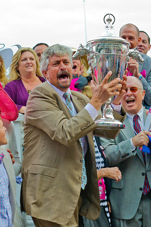 Trainer Steve Asmussen is ecstatic while holding the Kentucky Oaks trophy after Untapable won the 140th Kentucky Oaks.